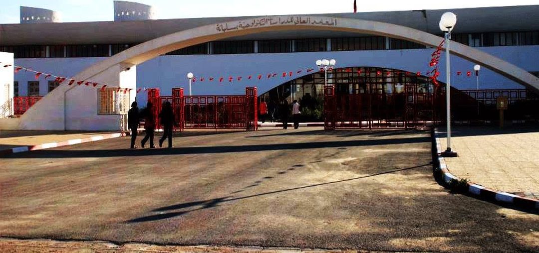 The arched entrance of ISET Siliana (Higher Institute of Technological Studies of Siliana), decorated with Tunisian flags